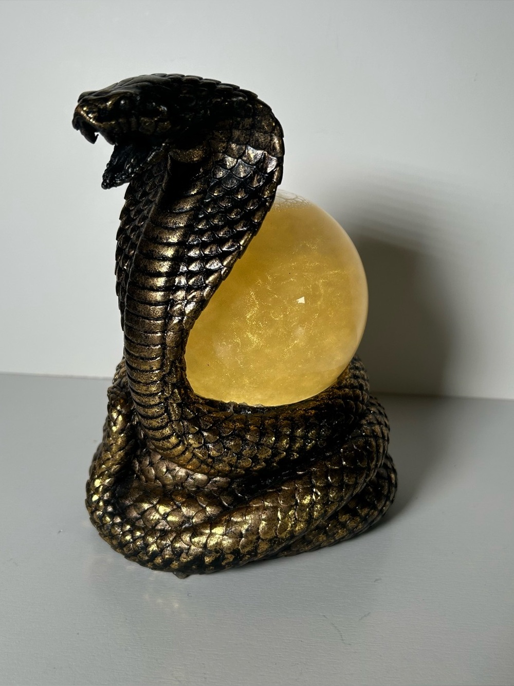 Eye-catching cobra snake figurine featuring a coiled body, raised hood, and deta